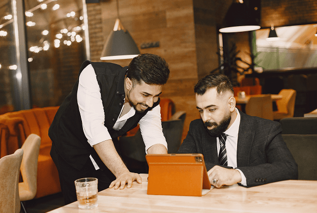 Two men discussing business in a restaurant setting